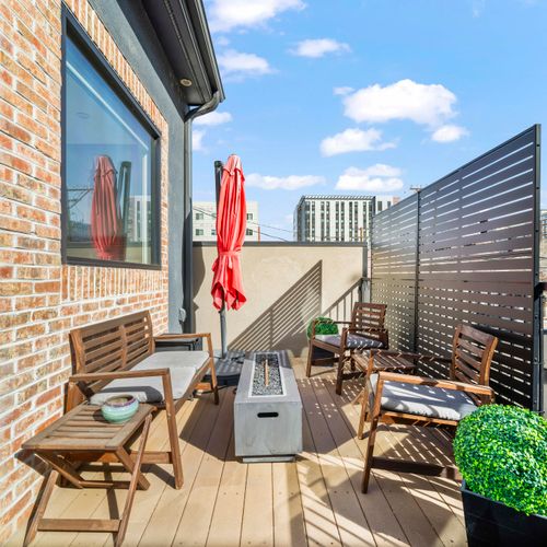Private outdoor deck with seating, fire pit, and city views for relaxing evenings.