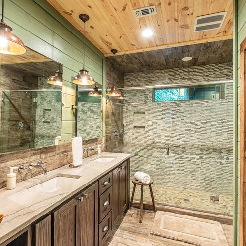 The private bathroom attached has a double vanity and a walk-in shower.
