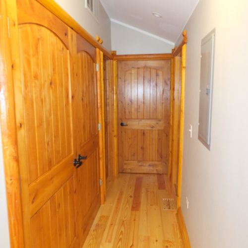 Hallway:  this hallway from the kitchen leads to each of the 3 bedrooms as well as the washer and dryer. The washer and dryer are behind the double doors near the front of the photo. The doors to each of the 3 bedrooms are at the end of the hall.