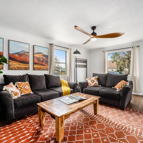 Upstairs living room features two plush couches, electric fireplace and new smart tv.