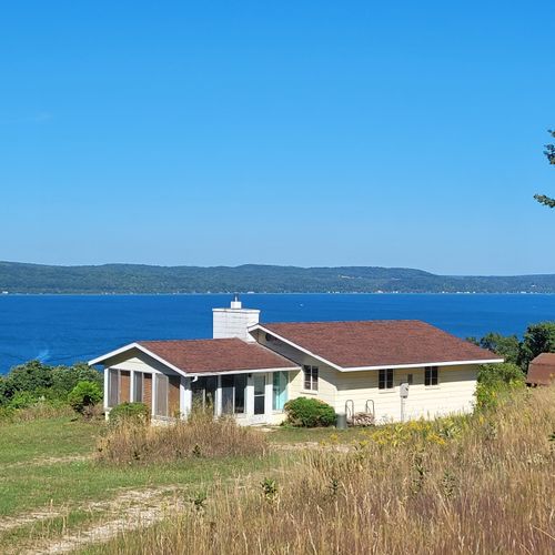 Exterior:  another view of the cottage with crystal lake in the background.
