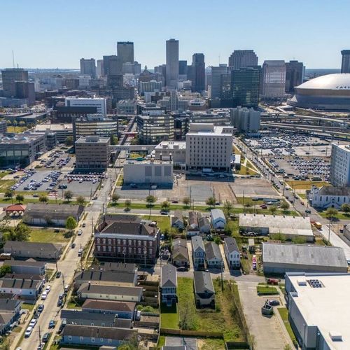Sweeping aerial view of the vibrant neighborhood & city beyond.