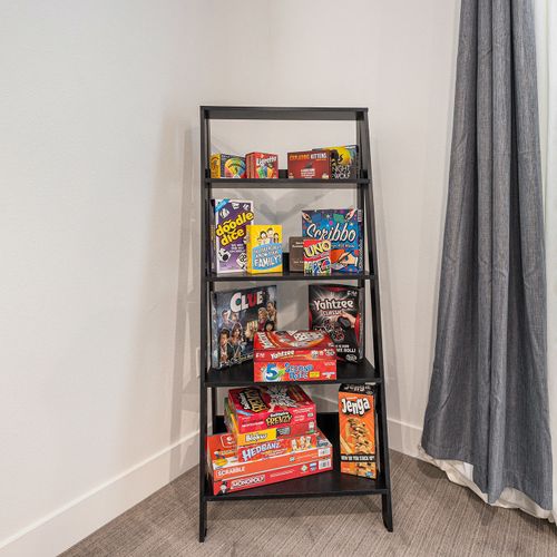 Gather for laughs, cards, or quiet time—there’s a whole shelf of board games waiting for you.