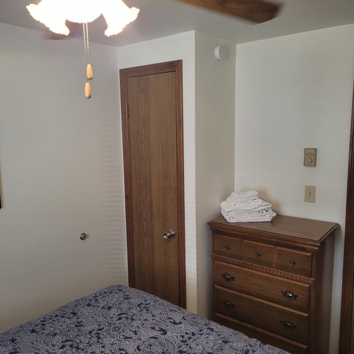 Bedroom #2:  features a full-size bed, ceiling fan, dresser, and closet.