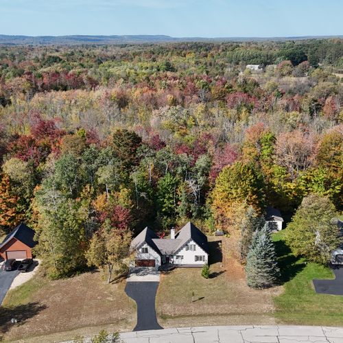 EXTERIOR:  Aerial view of the house and the beautiful forest and hills behind the house