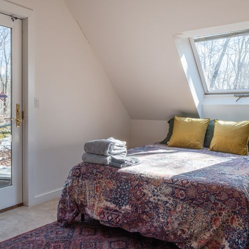 The queen bed in the loft bedroom.
