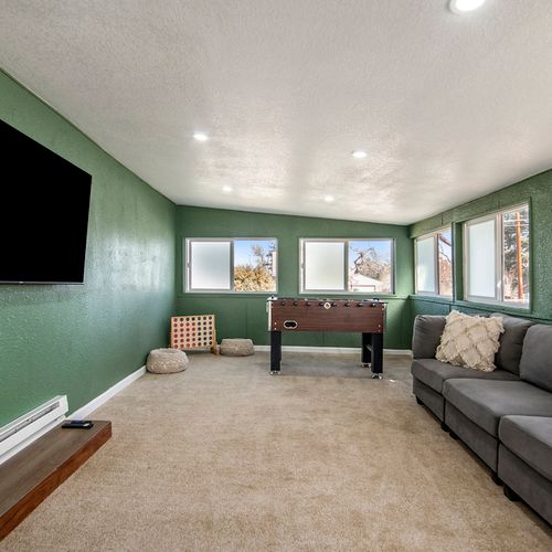 Sunny living room with ample natural light streaming in through large windows, creating a cozy and inviting ambiance around the tv.