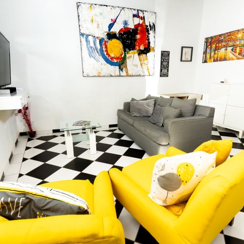 Feel a sense of fun and energy in this lively and inviting living room! The vibrant yellow pillows add a cheerful pop of color, making it the perfect spot to gather, converse, and create lasting memories.