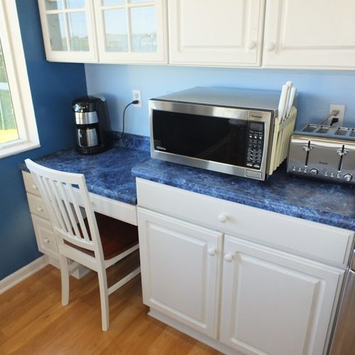 Kitchen:  another angle, showing the toaster, microwave, coffee maker, and the little desk / work area in the kitchen.