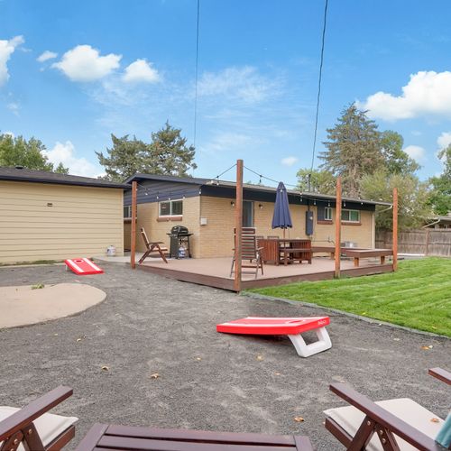 Step outside and enjoy the backyard oasis, featuring a ground-level patio deck with bbq, covered dining set, designated corn hole play space and recently installed hot tub!