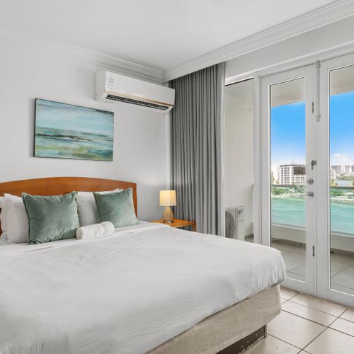 Expansive studio with direct balcony access, offering stunning water vistas and abundant natural light.