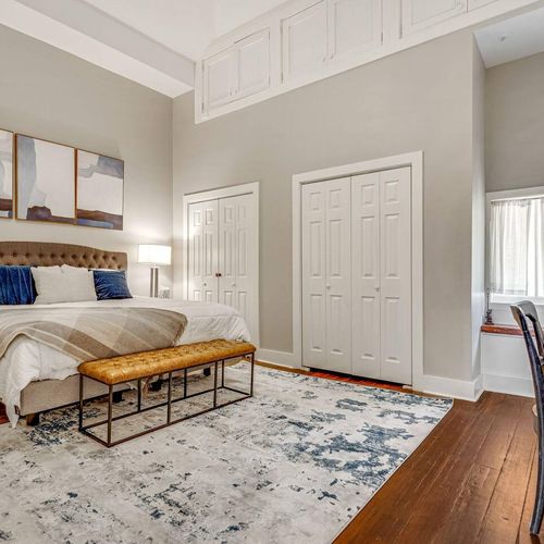 Sink into the king bed in this serene master bedroom w/ layered textures & warm tones.