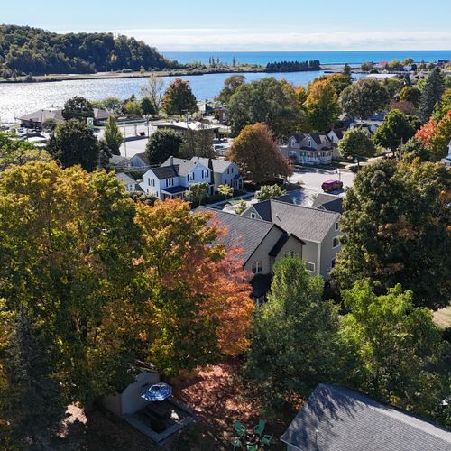 EXTERIOR:  Looking southwest from above the backyard towards Betsie Bay, the dunes of Elberta, Lake Michigan, and downtown Frankfort