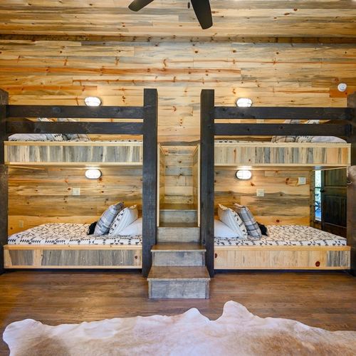 Bunk room with 2 queen beds, 2 full-size beds, 4 twin bed.s