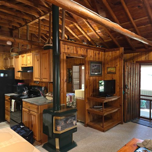 Living room:  the cabin has a very comfy and cozy living room with a sofa, comfy chair, gas fireplace, coffee table, and live streaming television with roku