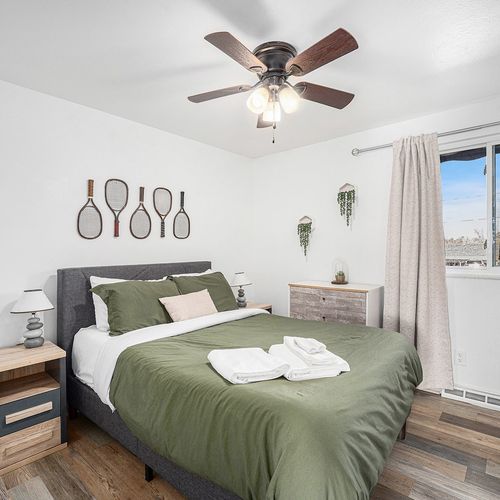 - recharge in a serene bedroom filled with light, greenery, and personal touches
- comfy bedding, stylish accents, and playful wall décor create a warm escape
- enjoy restful nights and sunny mornings in this beautifully balanced space