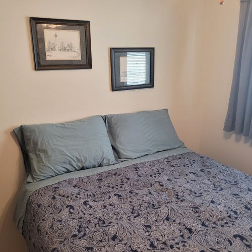 Bedroom #2:  features a full-size bed, ceiling fan, dresser, and closet.