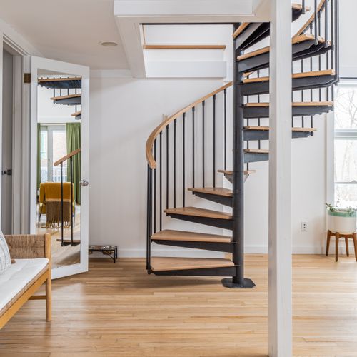 Spiral stairs lead up to the guest house loft.