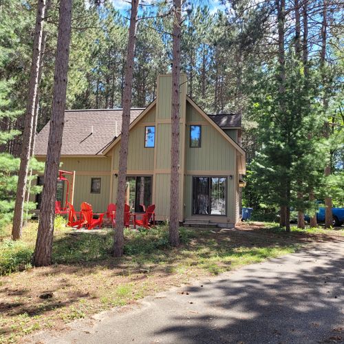 EXTERIOR:  The front of the cabin and the driveway