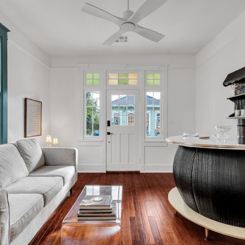 Airy living area w/ bar seating & sunlit French doors that open up the whole space.