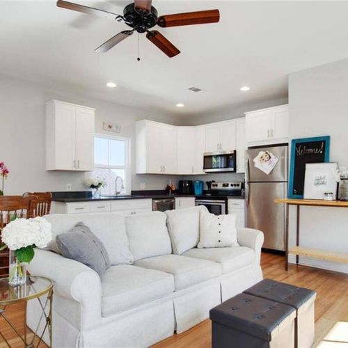 Airy living room w/ a comfy couch — light, white & made for lounging.