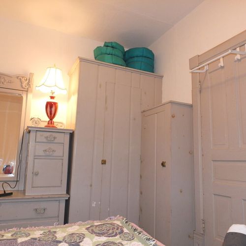 Bedroom #1 (main floor):  features a queen-size bed, mirror, dresser, and closet.