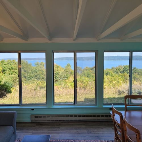 Sunroom:  the cottage has a very fun and family-friendly sunroom with a dining / game table, sofa, comfy chair, and a great view of crystal lake