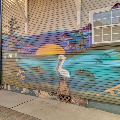 Capture the essence of New Orleans with this vibrant mural featuring the bayou, pelicans, and a jazz-inspired trumpet—a true reflection of the city's spirit.