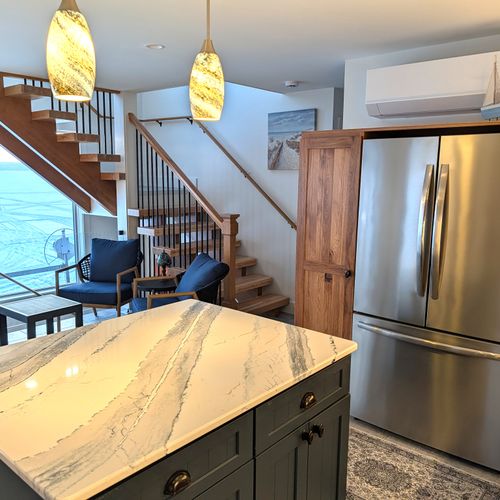 KITCHEN (MAIN FLOOR):  The home has a new and modern kitchen with all appliances including a dishwasher.  Also includes a coffee bar, kitchen island, and bar stools.