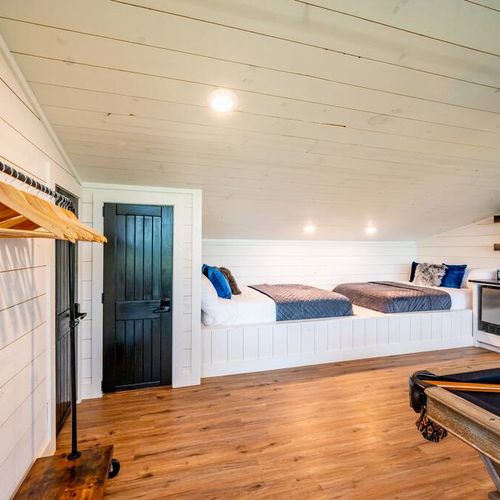 This bunk room features 2 full beds and 1 queen sleeper sofa!