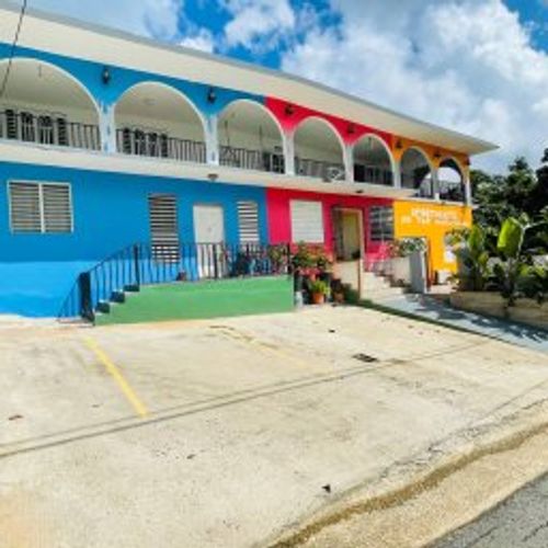 Experience vibrant living! Our beautifully maintained building boasts a cheerful exterior and ample outdoor space, perfect for enjoying the sunshine and fresh air.