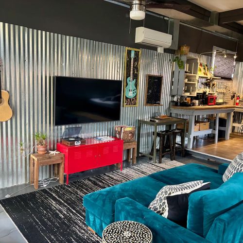 Industrial-cool living space w/ a warm, lived-in vibe — unwind & recharge.