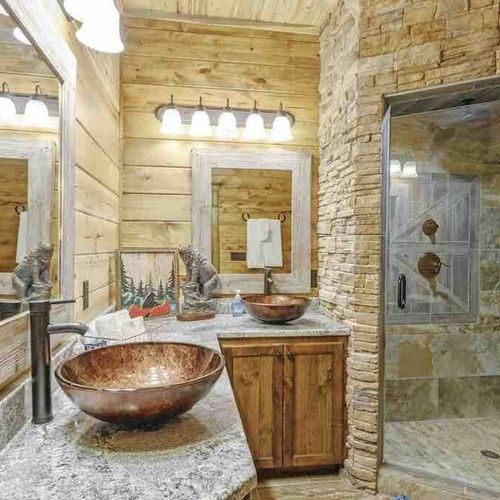 Bathroom attached to Master Suite 5. Features stone walk-in shower & double sink