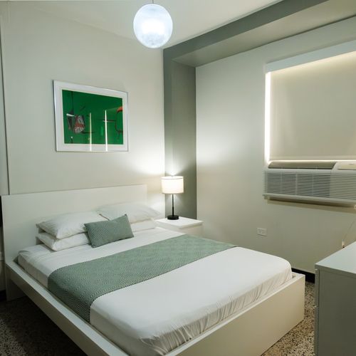 Step into your peaceful escape! This bright bedroom offers a comfortable queen bed, modern amenities, and a soothing atmosphere perfect for unwinding after a busy day.
