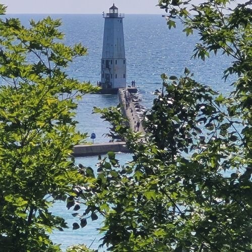 Exterior:  looking out at the frankfort pier and lighthouse from the back deck. (note that the camera has zoomed in on the pier and lighthouse. )