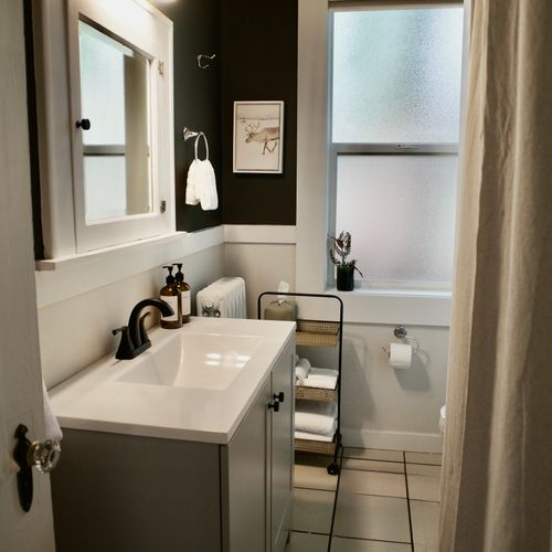 Bright and spotless upstairs bathroom for a fresh feel.