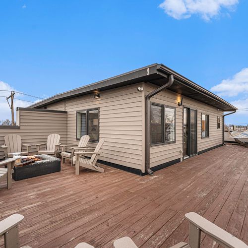 Relax and unwind in style on our spacious rooftop deck, complete with comfortable seating, a cozy firepit, and a hammock for ultimate relaxation.