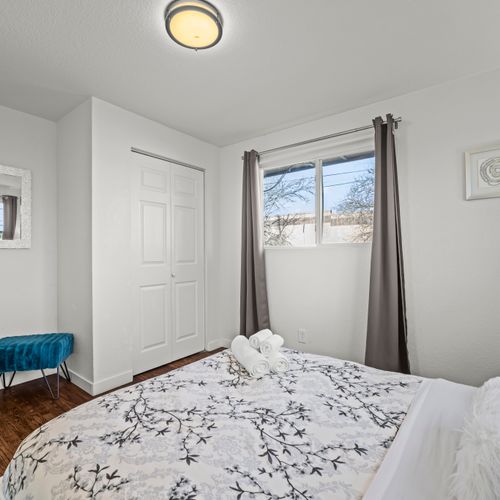 Upstairs bedroom with natural light or darkening shades for restful sleep.