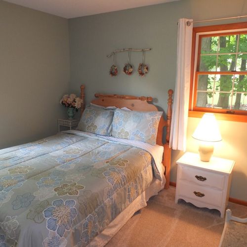 Bedroom #2: features a full-size bed, chair, nightstand, lamp, dresser, and closet.