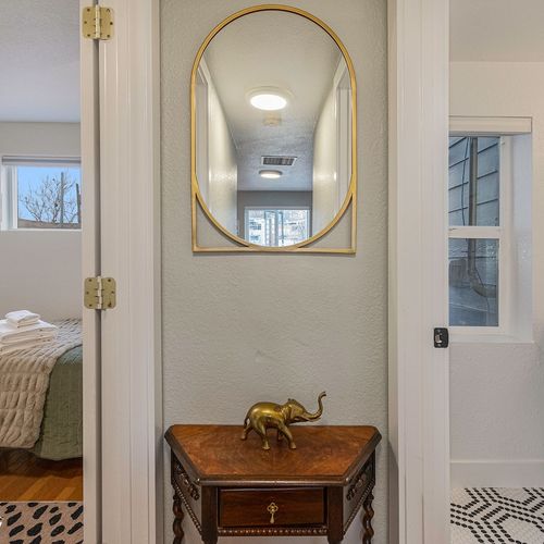 This homespace is elegantly accented with vintage antiquities and polished brass.