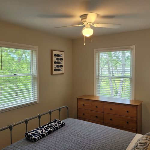 Bedroom #1:  bedroom #1 features a queen-size bed, ceiling fan, dresser, and a closet.