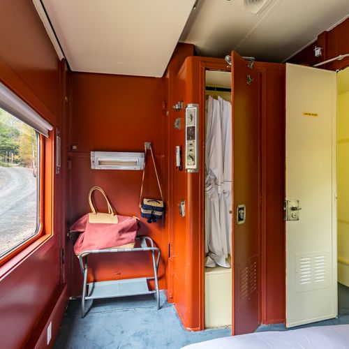 The Empire Suite equipped with a closet, bedside table, robes and slippers.