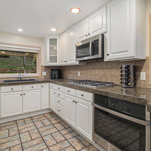 Spacious kitchen with high-end appliances, ample counter space and cabinetry.