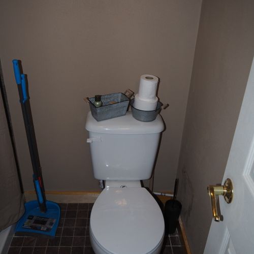 Bathroom:  features a shower and toilet. (note that there is no vanity, sink, or mirror in the bathroom. )
