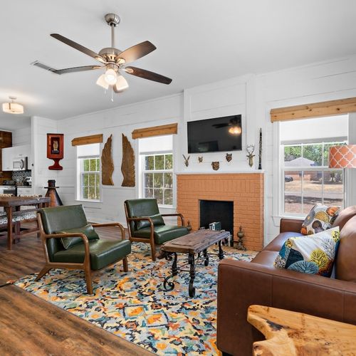 Living room and kitchen open room concept adjacent to the dining area and kitchen of the main house.
