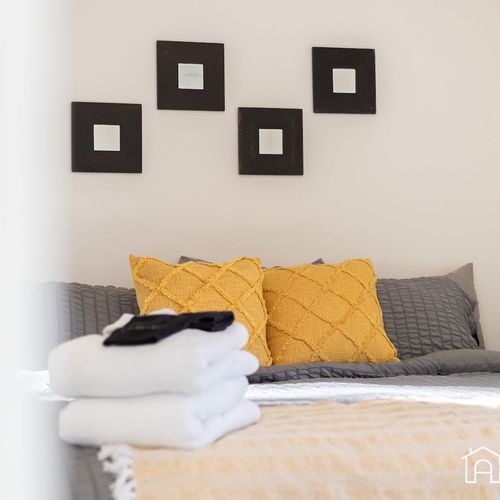 - soft bedding and textured pillows add a cozy pop of color to this relaxing retreat
- minimalist wall art frames the bed, tying together the modern decor
- peaceful space perfect for reading, napping, or winding down in style