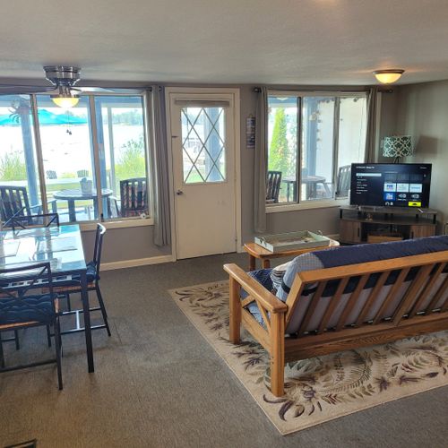 Living room:  cozy living room with a futon, chair, streaming television, and a great view of van etten lake!
