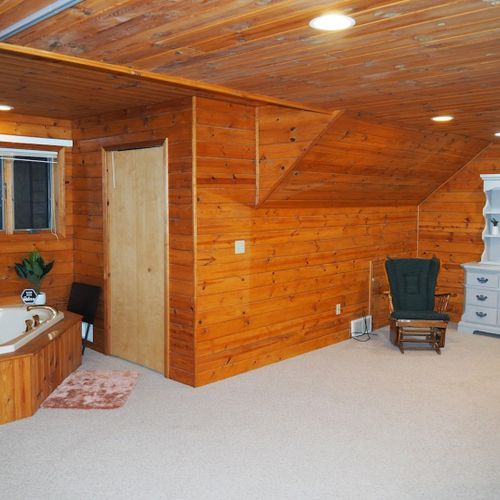 Bedroom #2 (second floor):  this is a huge upstairs bedroom with it's own television, desk, jetted tub, king-size bed, dresser, mirror, closet, and private en suite bathroom!