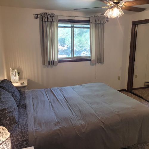 Bedroom #1:  features a sleep number adjustable queen-size bed, closet, ceiling fan, nightstands, and lamps.