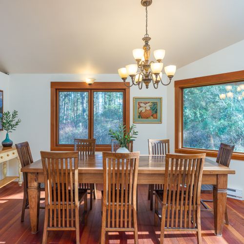 Large, country farm table open to the pond and woods